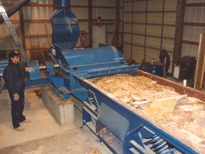 Horizontal feed wood hog for reducing long, oversized feed materials - Williams Patent Crusher
